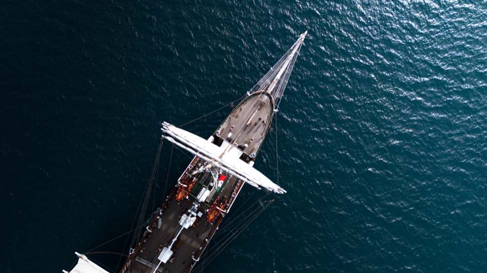 Aerial view of a sailing ship on deep blue water