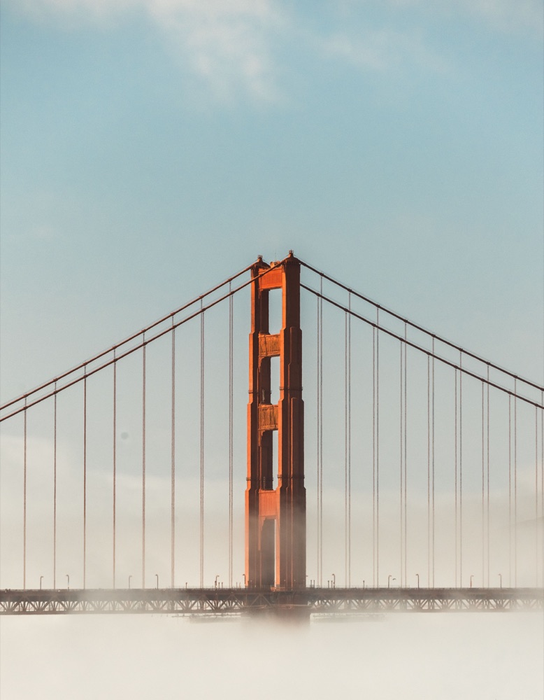 Golden Gate Bridge rising through fog